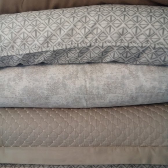Arrangement of vibrant pillowcases in shades in creams and tans.